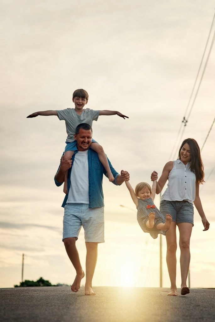 Shot of a young family walking together in the neighbourhood